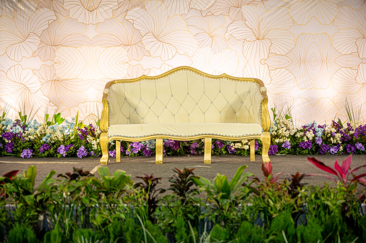 Birthday Party Venue Nashik – Elegant sofa setup with floral pillars at Vrindavan Greens